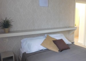 Double bedroom with shelf above the bed for emptying pockets, wardrobe, private bathroom in the room.