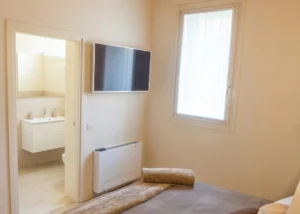 Double bedroom with shelf above the bed for emptying pockets, wardrobe, private bathroom in the room.